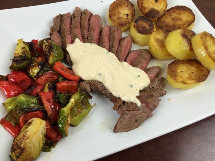 Sirloin Steak and Fondant Potatoes with Chive-Horseradish Sauce, Roasted Red Pepper, and Brussels