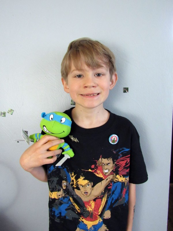 J is modeling the t-shirt, 2 pins, and holding Leonardo.