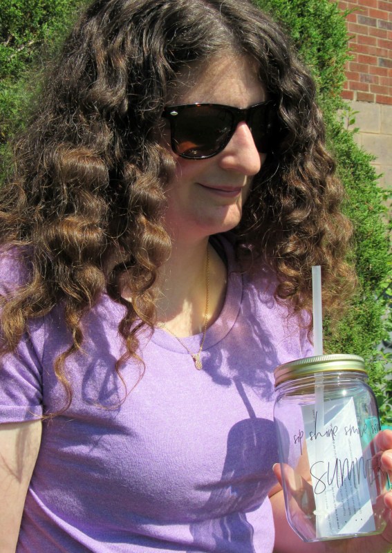 Wearing the sunnies, necklace, and holding the tumbler